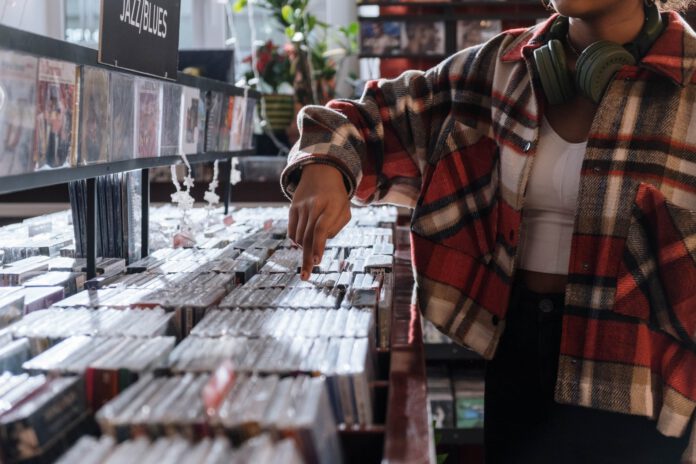 person wearing a checkered shirt in the record store